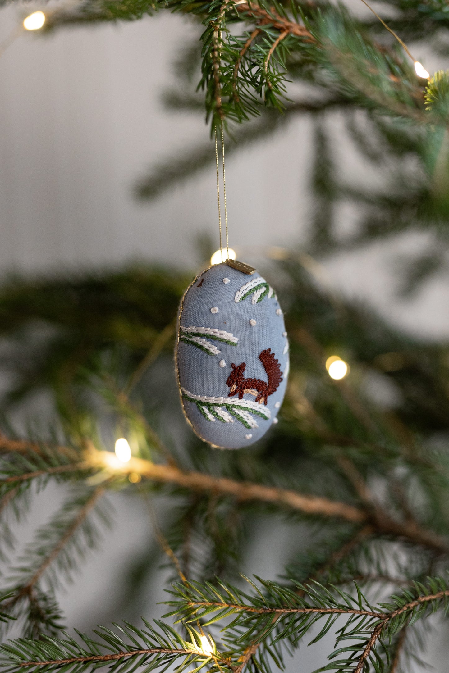 Embroidered oval ornament, squirrel